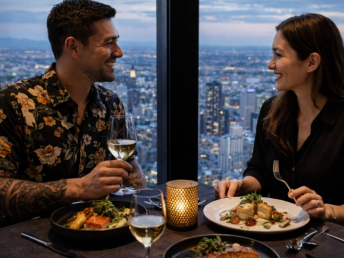 Couple enjoying fine dining with white wine at a sky-high restaurant in Melbourne, Australia | panoramic city skyline views at dusk