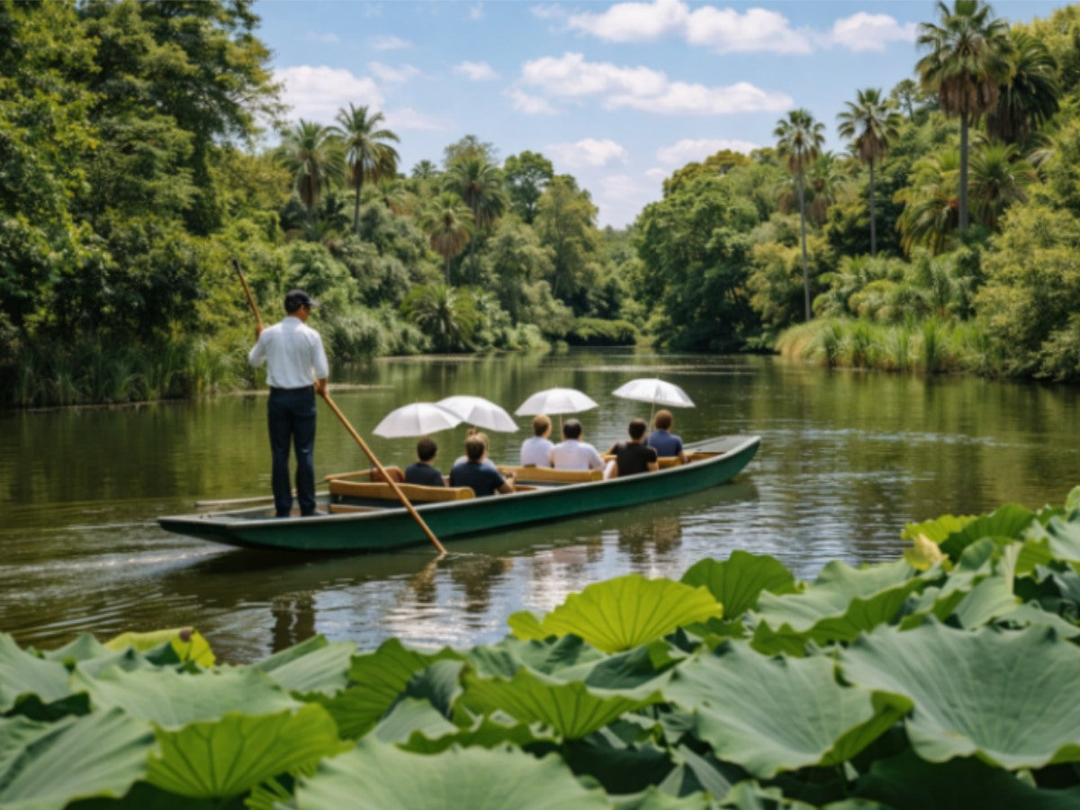 Guided boat tour on the lake at Royal Botanic Gardens Cranbourne, surrounded by tropical palms and lotus leaves, Australia